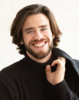 Zachary_Amos seen in a full black color outfit and a bright smile on his face